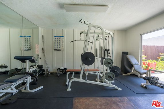 Interior view of a home gym with various exercise equipment.