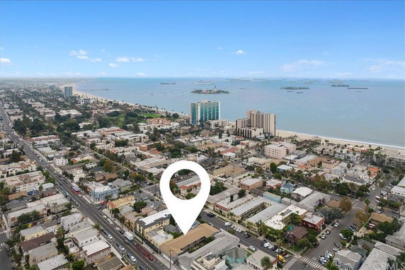Aerial view of a coastal city with buildings and ocean.