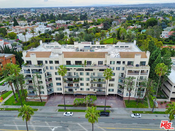 Front view of a multi-story apartment building with balconies.