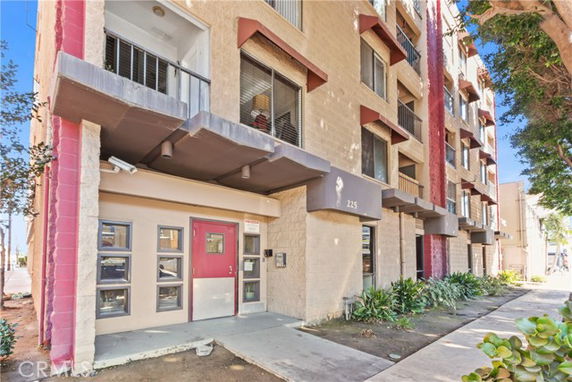 Front view of a multi-story apartment building with entrance.