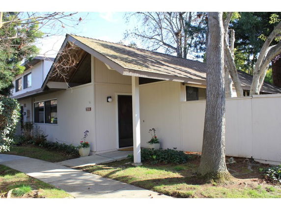 Front view of a single-story house with a sloped roof and simple entrance.
