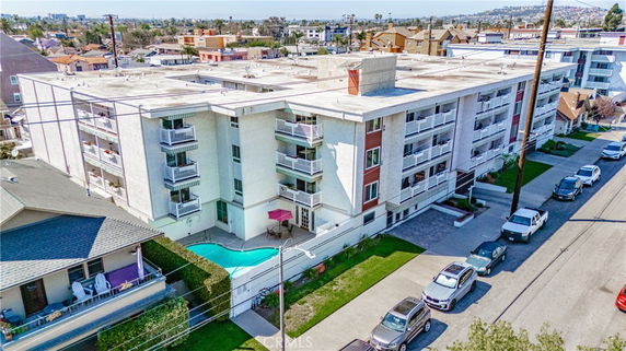 Front view of a multi-story apartment building with balconies.