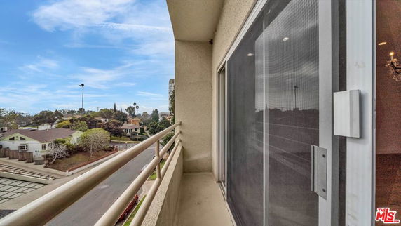 View of residential area and street from a building balcony.