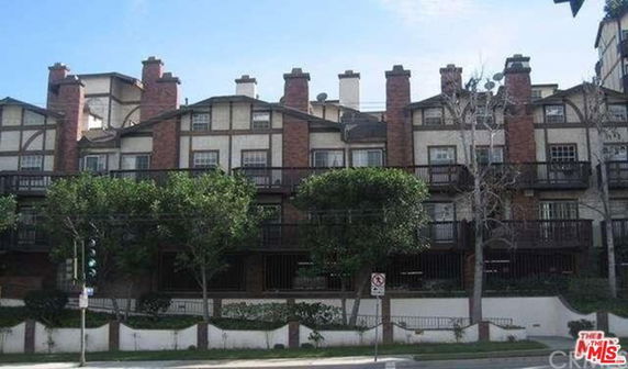 Front view of a multi-story townhouse complex with modern architecture.