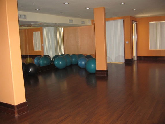 Room with exercise balls and wooden flooring, possibly used for yoga or fitness.