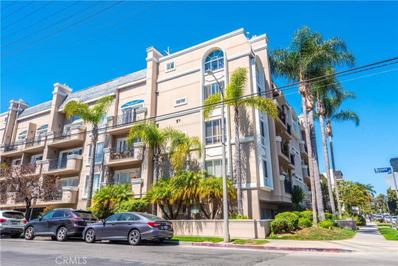 Front view of a multi-story apartment building with balconies.