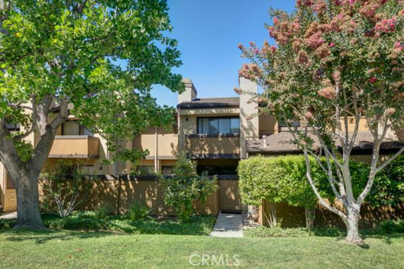 Front view of a two-story house with balconies and a chimney.
