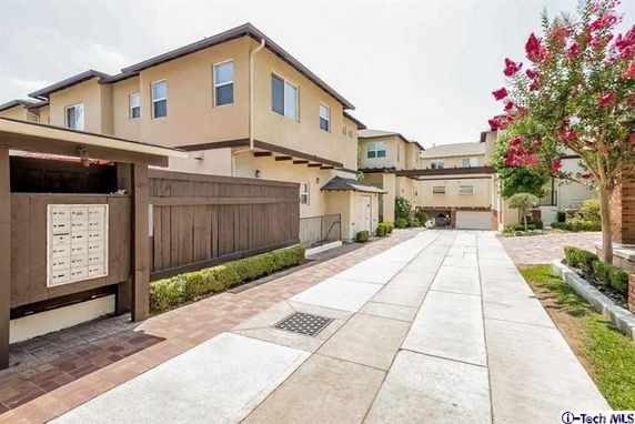 Front view of a multi-story house with a shared driveway