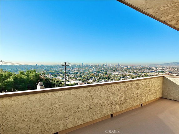 Panoramic view of a cityscape from a building balcony.