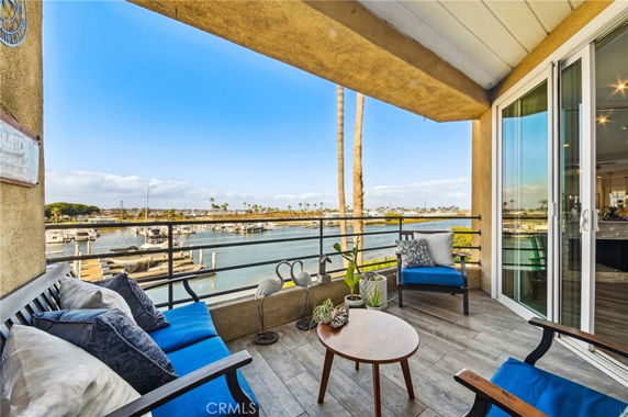 Outdoor patio with seating overlooking a marina and waterfront view.