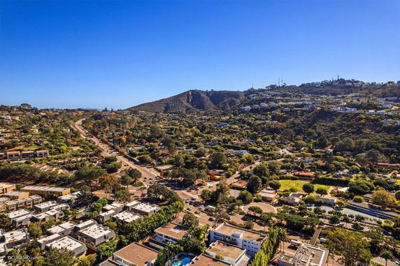 Panoramic view of a residential area with hills in the background.