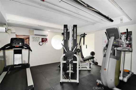 Indoor gym with exercise equipment including treadmills and weight machines.
