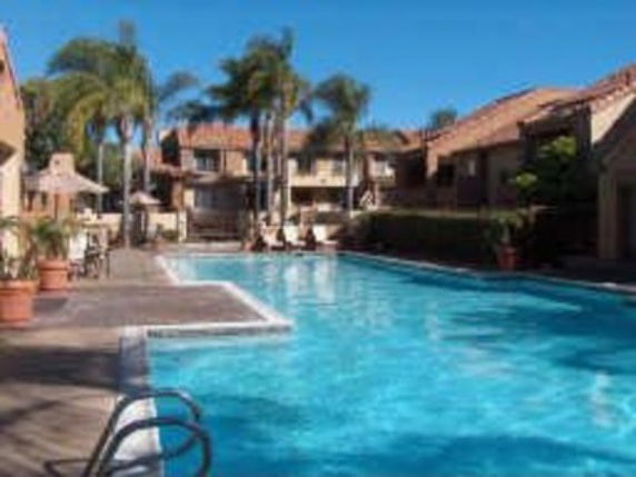 Outdoor swimming pool with surrounding residential buildings.
