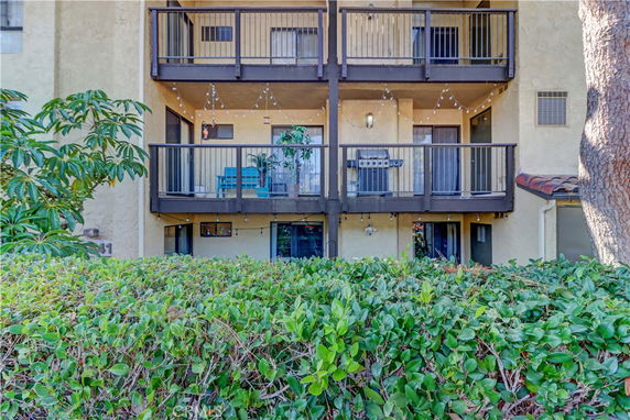 Front view of a multi-story building with balconies.