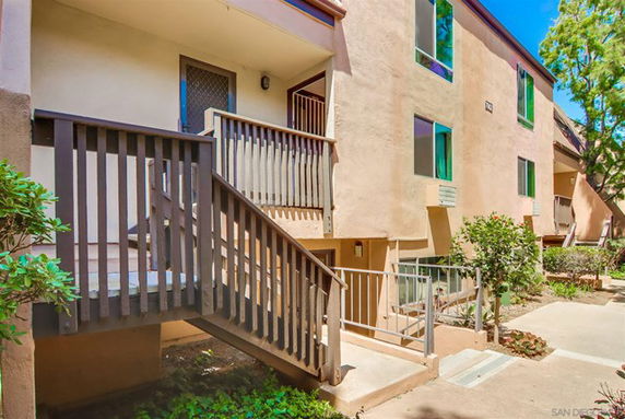 Front view of a multi-story residential building with stair access.