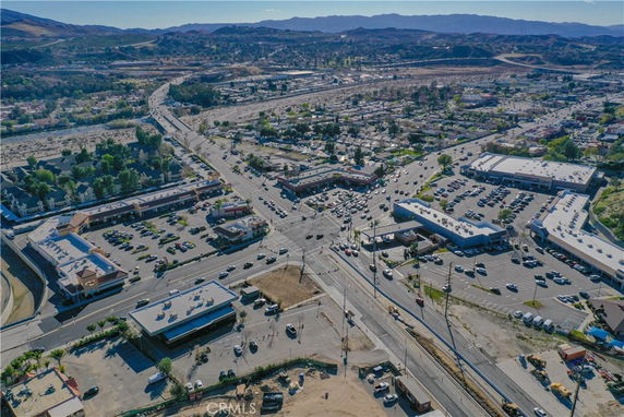 Panoramic view of an urban area with roads, parking lots, and buildings.