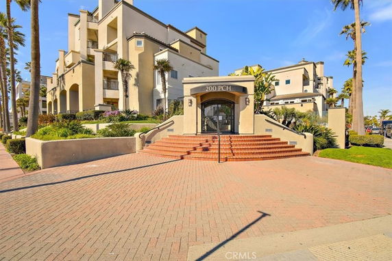 Front view of a multi-story residential building with an entrance staircase.