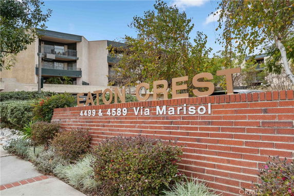 Front view of a multi-story residential building with balconies.