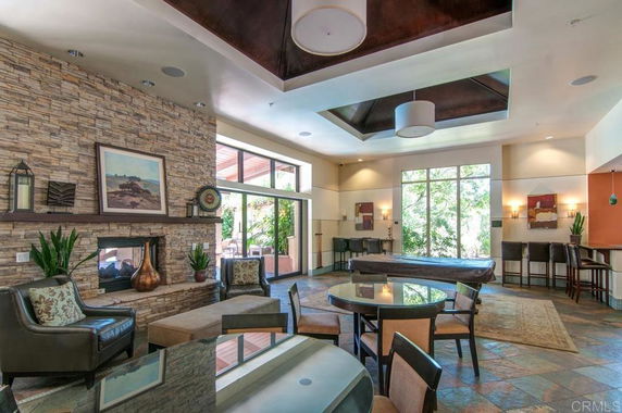 Interior of a clubhouse with seating area and pool table.