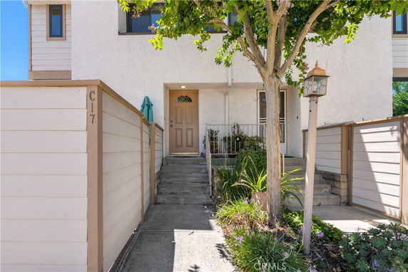 Front view of a townhouse with steps leading up to the entrance.