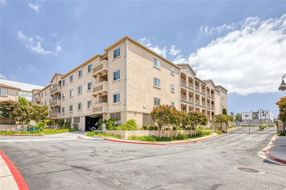 Front view of a multi-story apartment building with balconies.