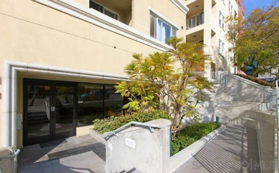 Front view of a multi-story apartment building entrance.