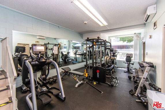 Indoor gym with exercise equipment and large mirrors