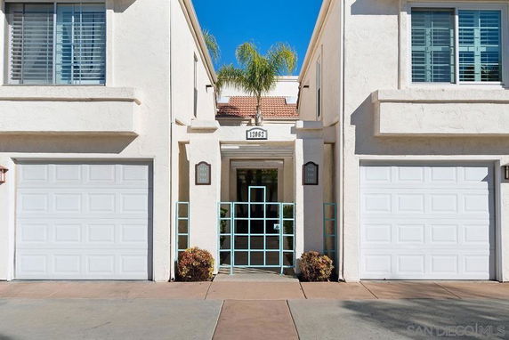 Front view of a house with two garages and a central entrance.