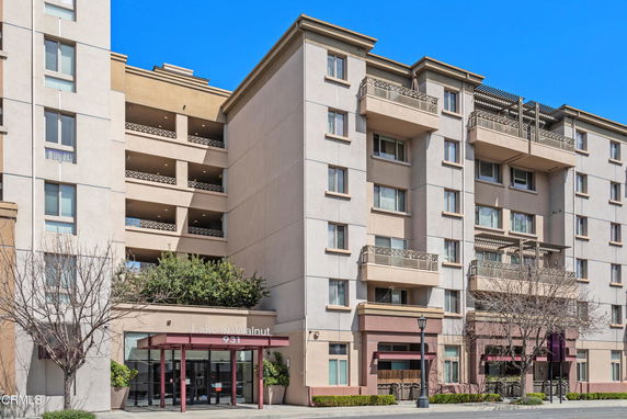 Front view of a multi-story residential building with balconies.