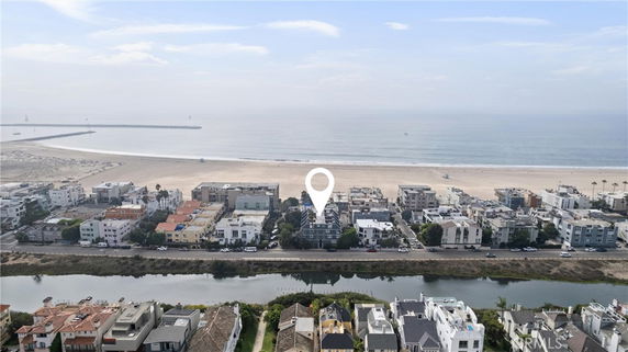 Panoramic view of seaside buildings and beach.