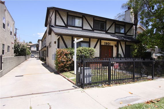 Front view of a two-story house with a gated entrance.