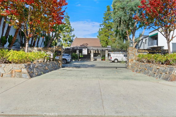 Front view of a building with a gated entrance and signage 'California Place'.