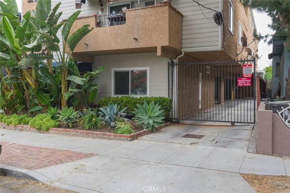 Front view of a multi-story building with a gated entry.