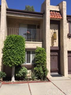 Front view of a two-story house with a small balcony and a front door.