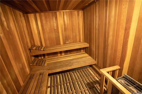 Interior view of a wooden sauna room with benches.