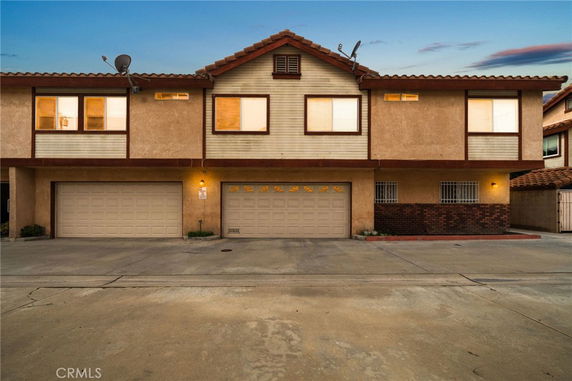 Front view of a two-story townhouse with double garages.