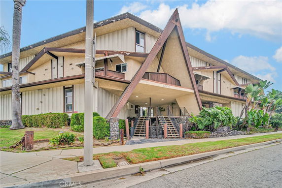 Front view of a multi-story building with an A-frame entrance.