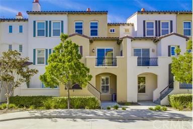 Front view of a multi-story townhouse with balconies.