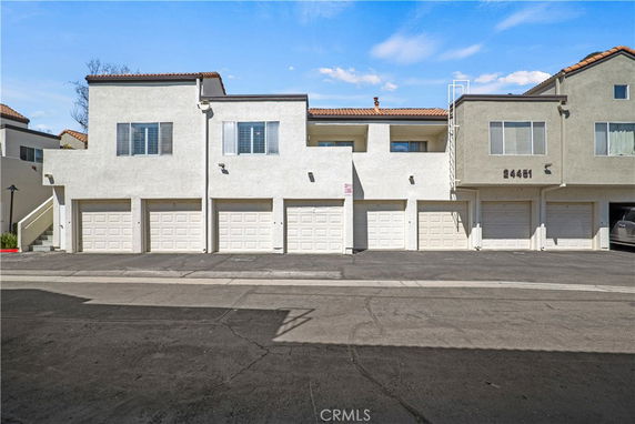 Front view of a multi-story building with garages.