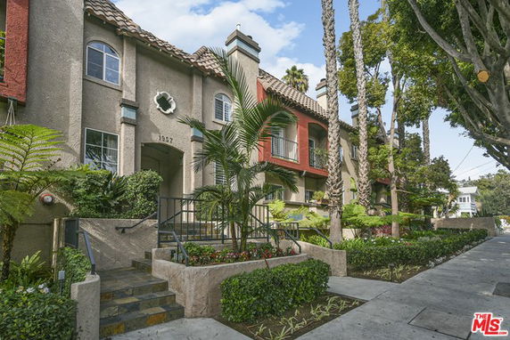 Front view of a multi-story residential building with a decorative entrance.