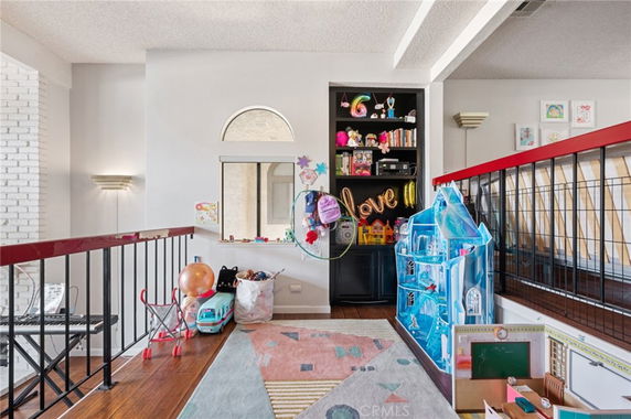 Indoor play area with toys, a mini castle, and open shelves.