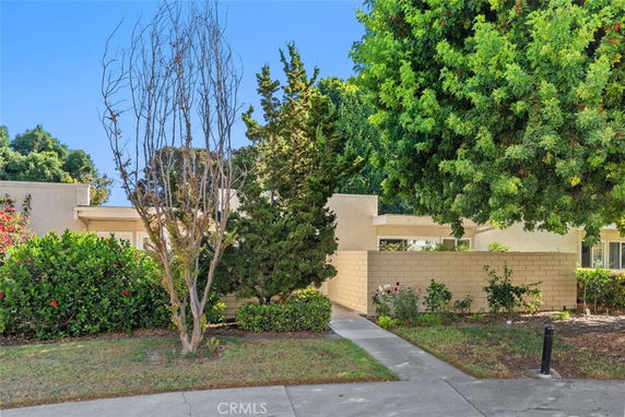 Front view of a house with a flat roof and brick wall.