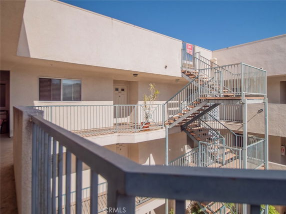 View of an apartment building exterior showing staircases and walkways.