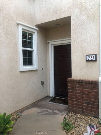 Front view of a house entrance with a door and window.