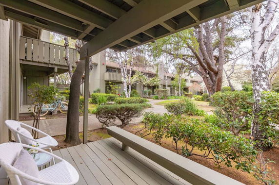 Outdoor patio view with residential buildings and trees.