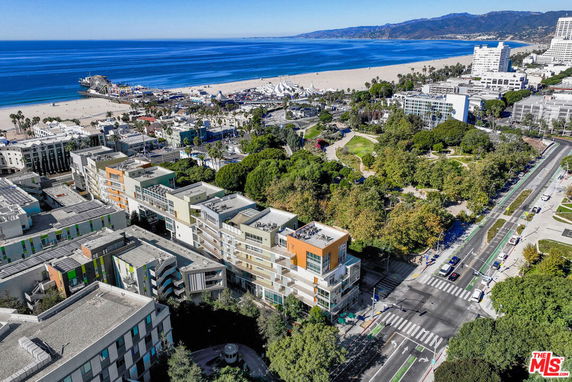 Panoramic view of coastal area with modern buildings and beach in the background.