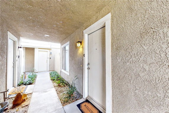 Entrance area of a residential building with visible doors and windows.
