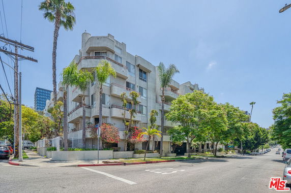 Front view of a multi-story building with balconies.