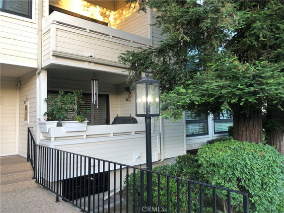 Front view of a house with a balcony and railing.