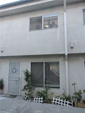 Front view of a two-story townhouse with a window and a door.